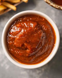 "Chef attempting to master the KFC sauce recipe in a modern kitchen."