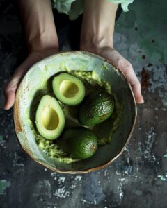 "Person preparing 4 ingredient guacamole recipe in rustic kitchen setting."